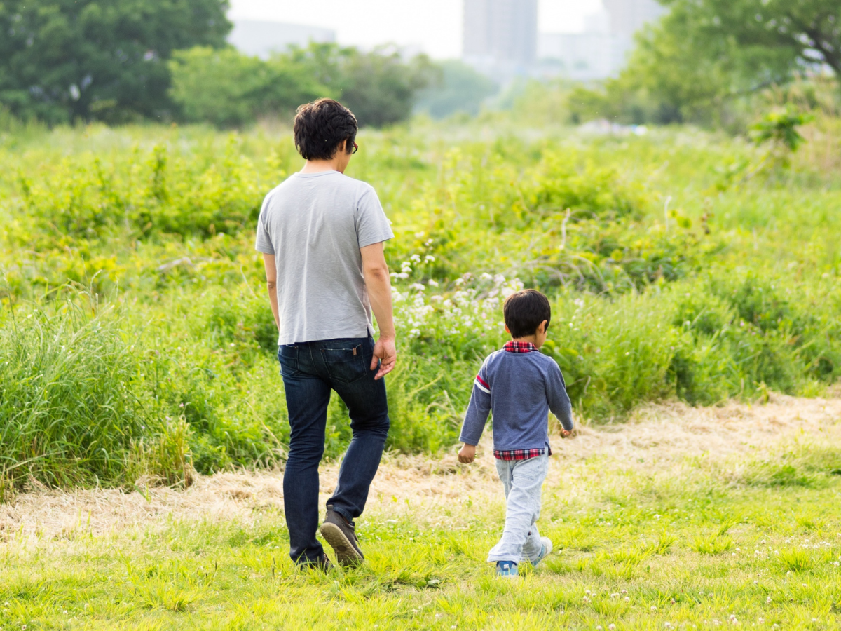 boy walking with his dad