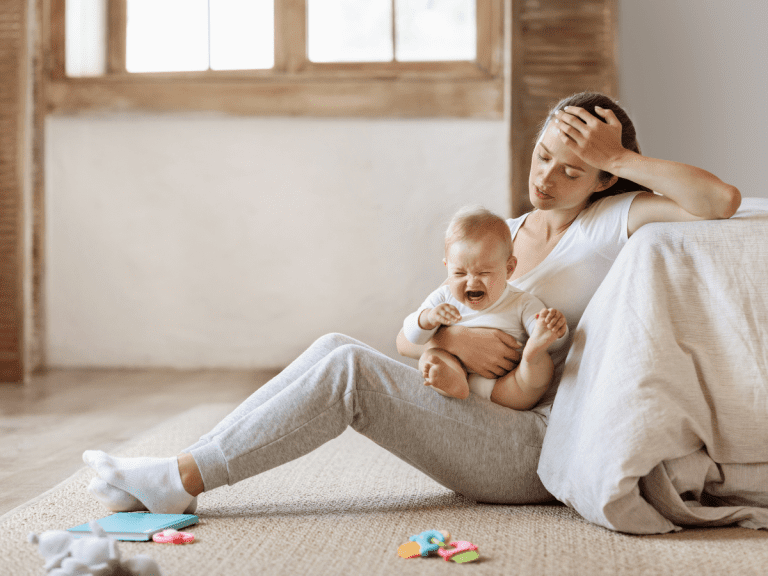 weary parent with crying child
