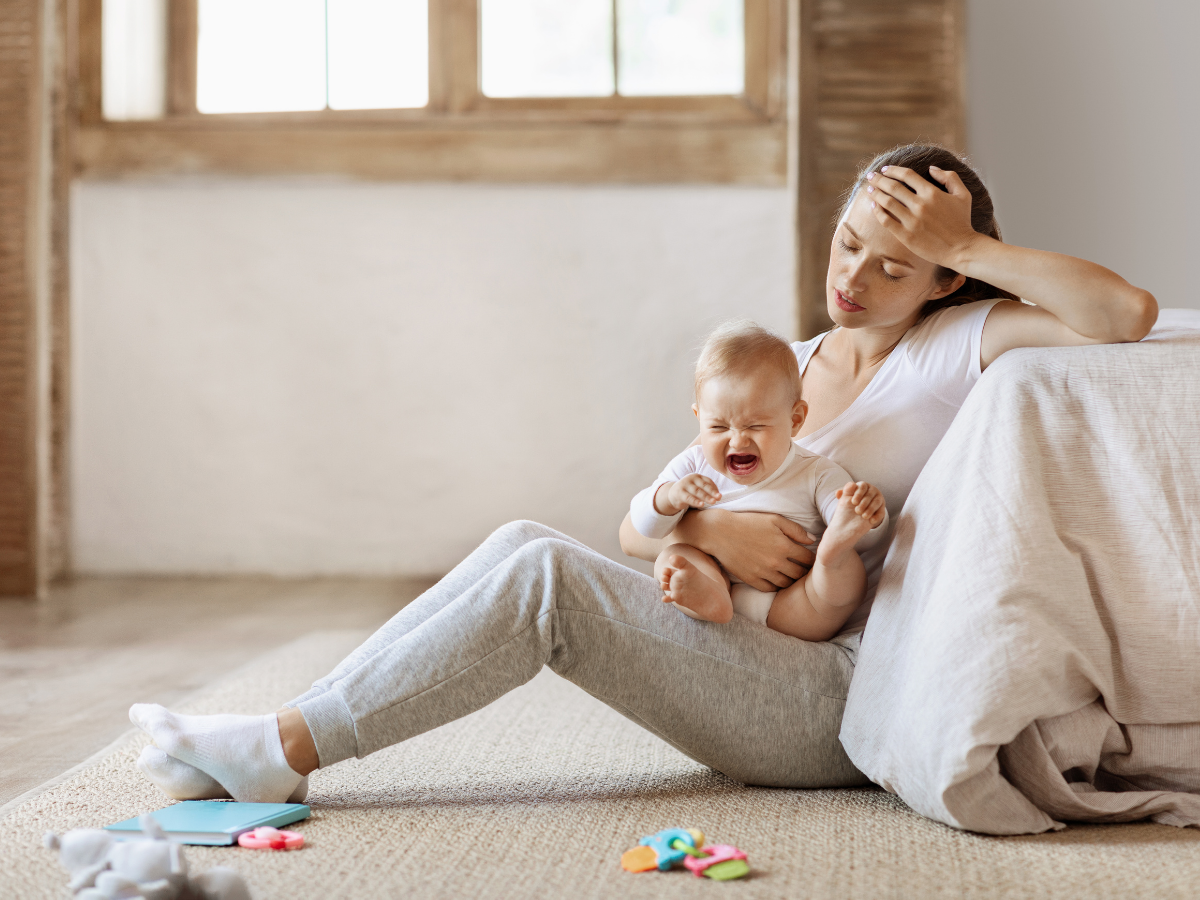 weary parent with crying child